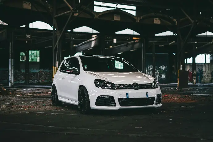 white bmw m 3 parked on parking lot during night time